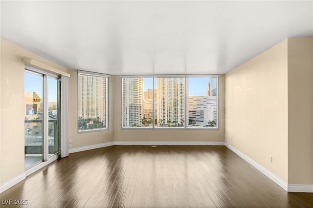 spare room with dark hardwood / wood-style floors