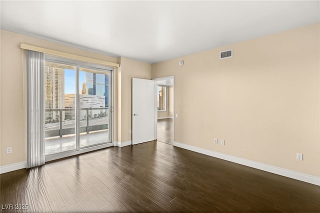 empty room featuring dark wood-type flooring