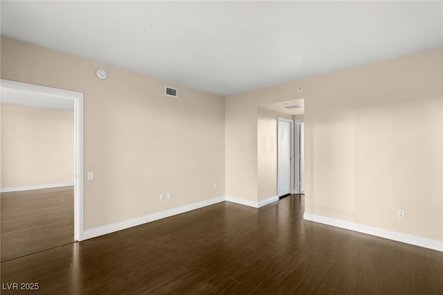 unfurnished room with dark hardwood / wood-style floors