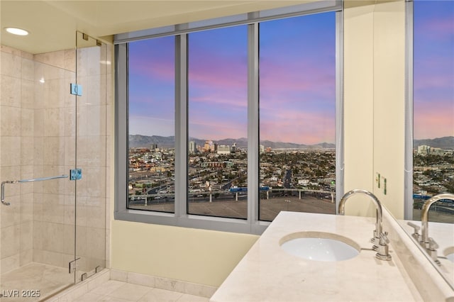 bathroom featuring vanity, tile patterned floors, a shower with door, and a mountain view