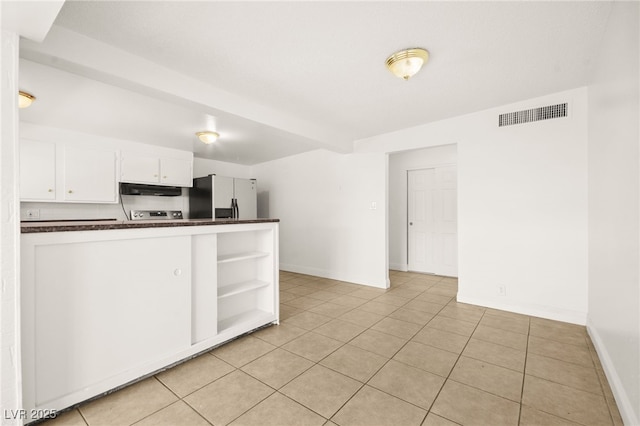 kitchen featuring kitchen peninsula, extractor fan, white cabinetry, fridge, and light tile patterned flooring