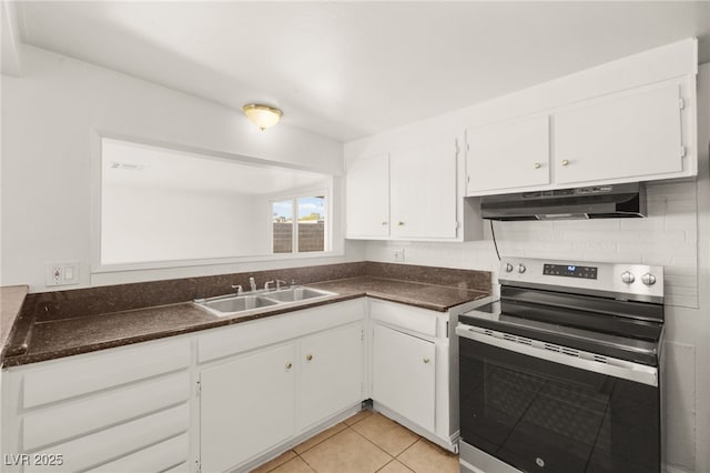 kitchen featuring stainless steel range with electric stovetop, light tile patterned flooring, white cabinetry, and sink