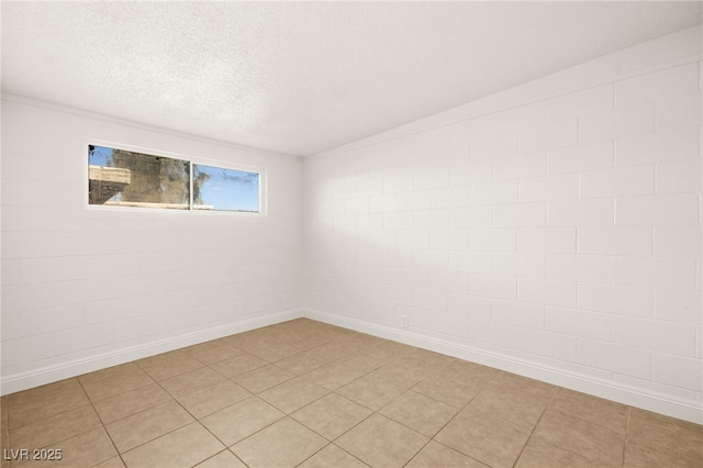 empty room featuring light tile patterned flooring and brick wall