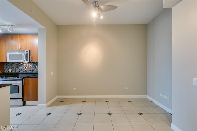 kitchen with light tile patterned flooring, backsplash, stainless steel range with electric stovetop, and ceiling fan