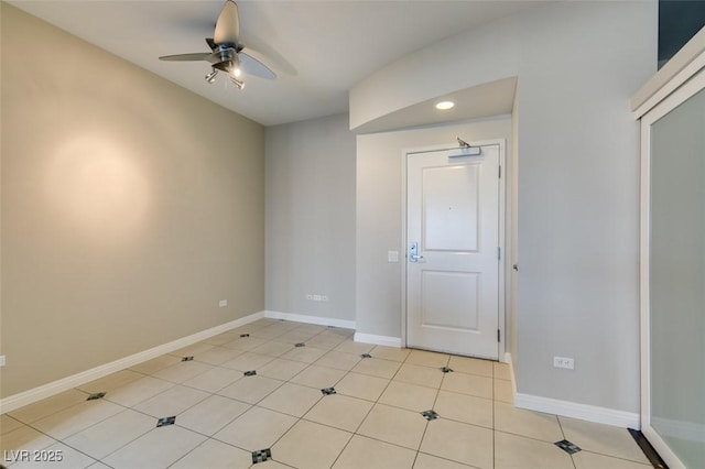 unfurnished room with ceiling fan and light tile patterned floors