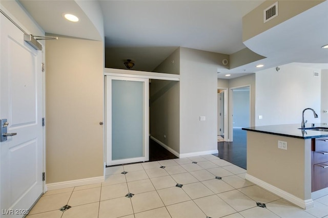 kitchen featuring light tile patterned floors and sink