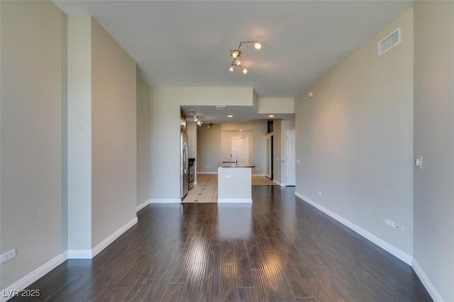 empty room with dark hardwood / wood-style flooring