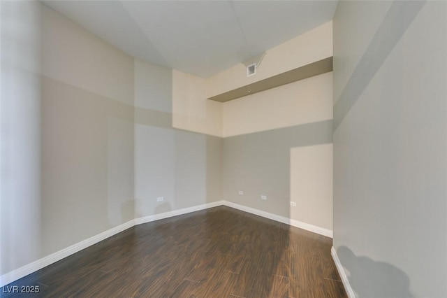 unfurnished room with dark hardwood / wood-style flooring