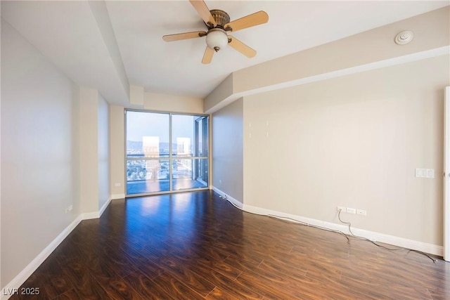 unfurnished room with ceiling fan and dark hardwood / wood-style flooring