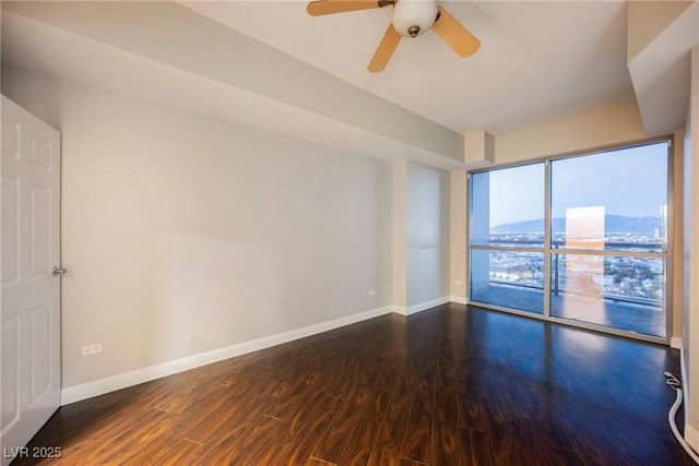 empty room featuring ceiling fan and dark hardwood / wood-style flooring