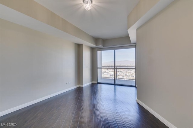 spare room featuring dark hardwood / wood-style floors