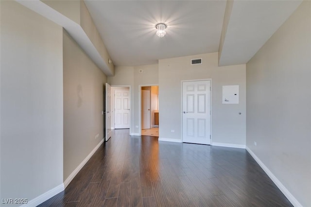 unfurnished room featuring dark wood-type flooring