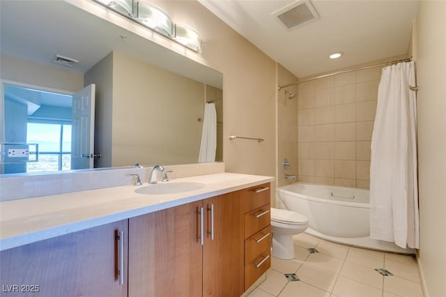 full bathroom featuring tile patterned floors, vanity, toilet, and shower / bath combo with shower curtain