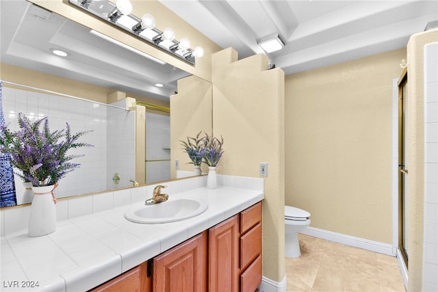 bathroom featuring tile patterned flooring, vanity, toilet, and walk in shower