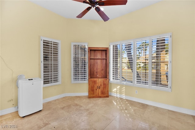 spare room featuring ceiling fan and light tile patterned flooring