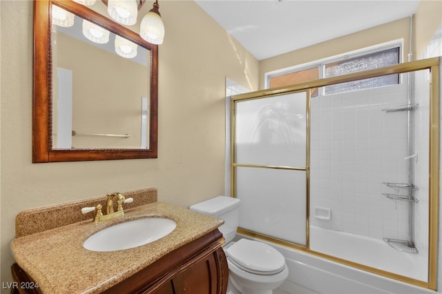 full bathroom featuring vanity, toilet, and combined bath / shower with glass door