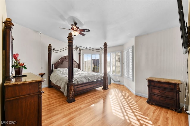 bedroom with light hardwood / wood-style flooring and ceiling fan