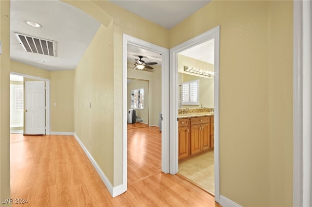 corridor with light wood-type flooring