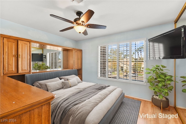 bedroom featuring ceiling fan and light hardwood / wood-style flooring