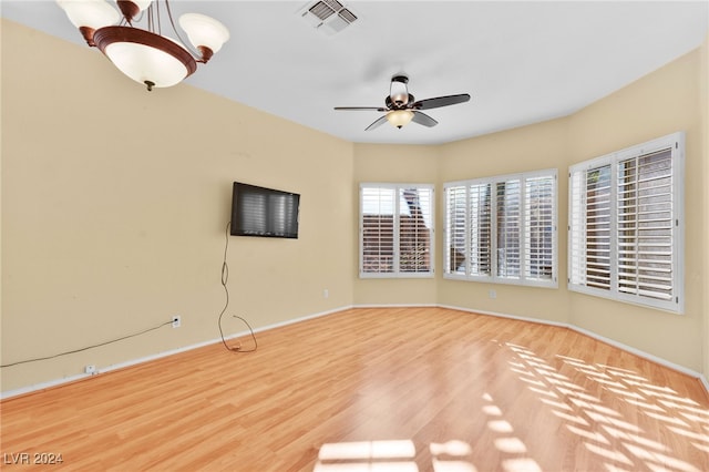 spare room with light wood-type flooring and ceiling fan