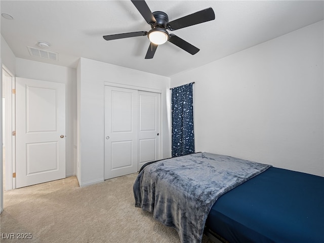 carpeted bedroom featuring a closet and ceiling fan