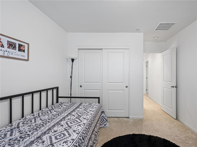 carpeted bedroom featuring a closet