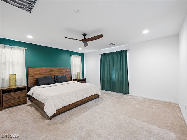 bedroom featuring ceiling fan, light carpet, and multiple windows