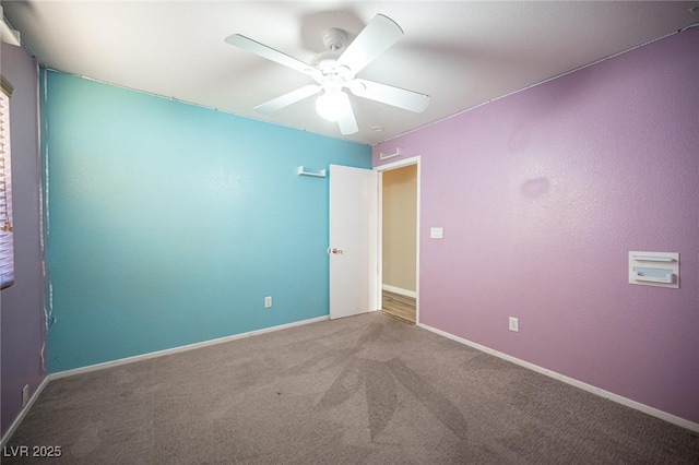 carpeted empty room featuring ceiling fan