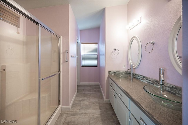 bathroom featuring vanity and a shower with door