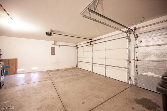 garage featuring electric panel and a garage door opener