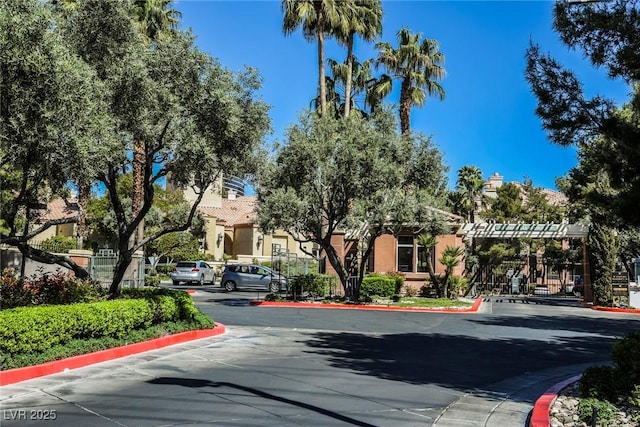 view of street featuring curbs and a gated entry