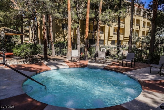 view of swimming pool with a pool, fence, and a patio