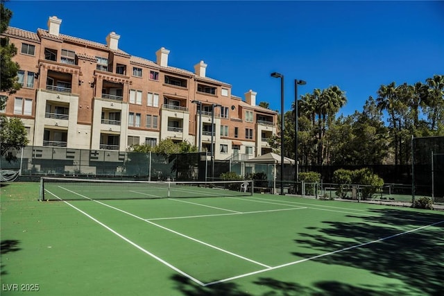 view of tennis court featuring fence