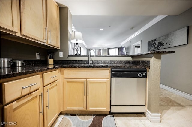 kitchen with dishwasher, ornamental molding, dark stone countertops, and a sink