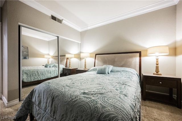 carpeted bedroom with visible vents, ornamental molding, and a closet