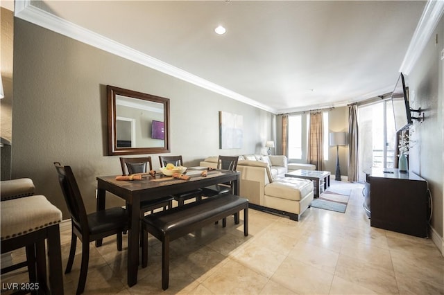 dining space featuring crown molding