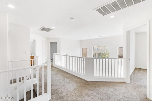 hallway with carpet floors