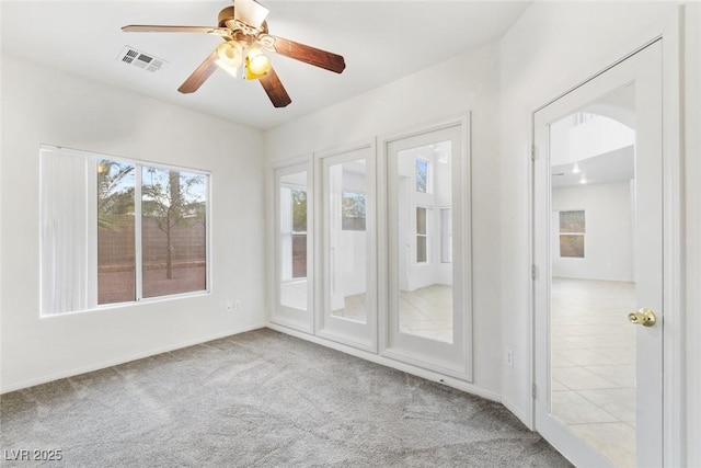 unfurnished sunroom with ceiling fan