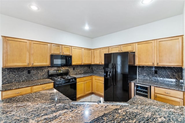 kitchen with tasteful backsplash, wine cooler, dark stone counters, and black appliances