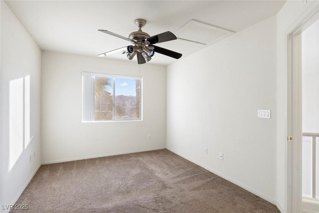 carpeted spare room featuring ceiling fan