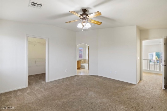 carpeted empty room featuring ceiling fan and vaulted ceiling