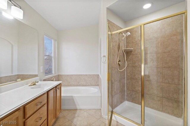 bathroom with tile patterned flooring, vanity, and separate shower and tub