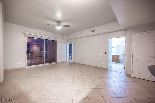 tiled empty room with ceiling fan