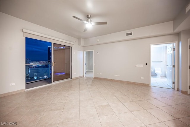 tiled spare room featuring ceiling fan