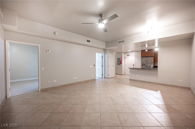 unfurnished living room with light tile patterned floors and ceiling fan