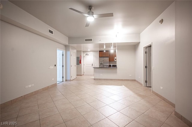 interior space with ceiling fan and light tile patterned floors