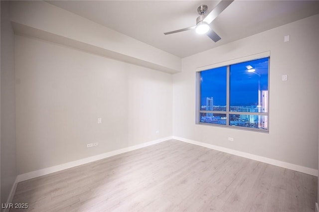 empty room with ceiling fan and light wood-type flooring