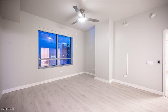 empty room with ceiling fan and light wood-type flooring