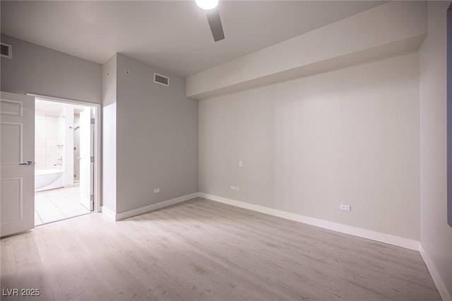 empty room with ceiling fan and light hardwood / wood-style floors