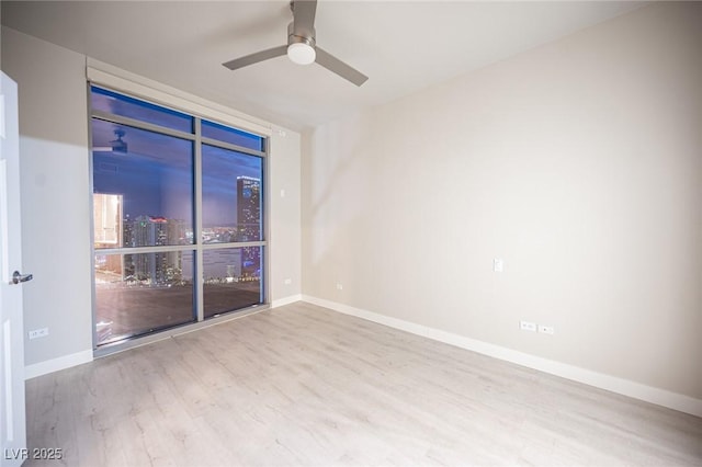 unfurnished room featuring light hardwood / wood-style flooring and ceiling fan